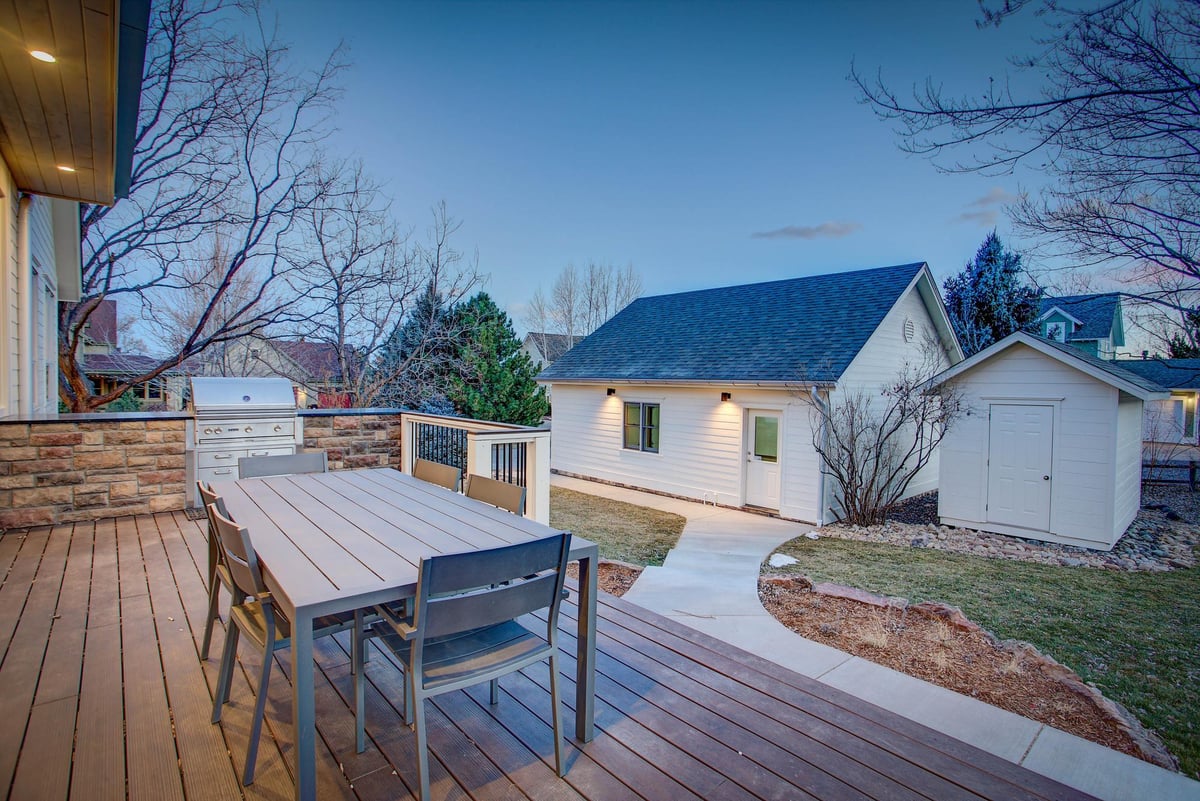 evening view of a new back porch and ADU