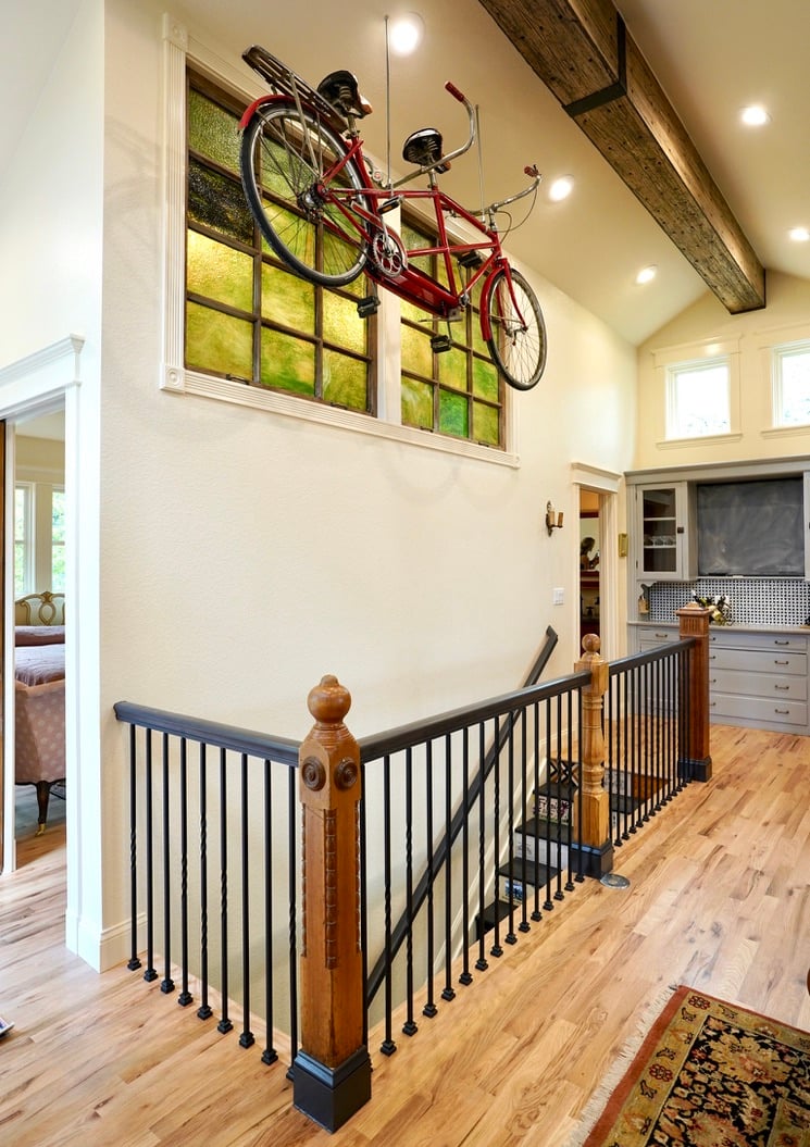 green stained glass and suspended bike from reclaimed wood beam