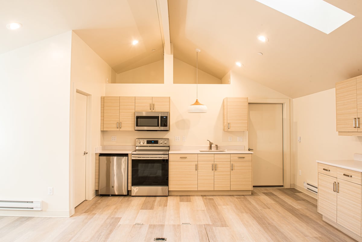 Warmly Lit Detached Workshop With Stainless Steel Microwave and Stove