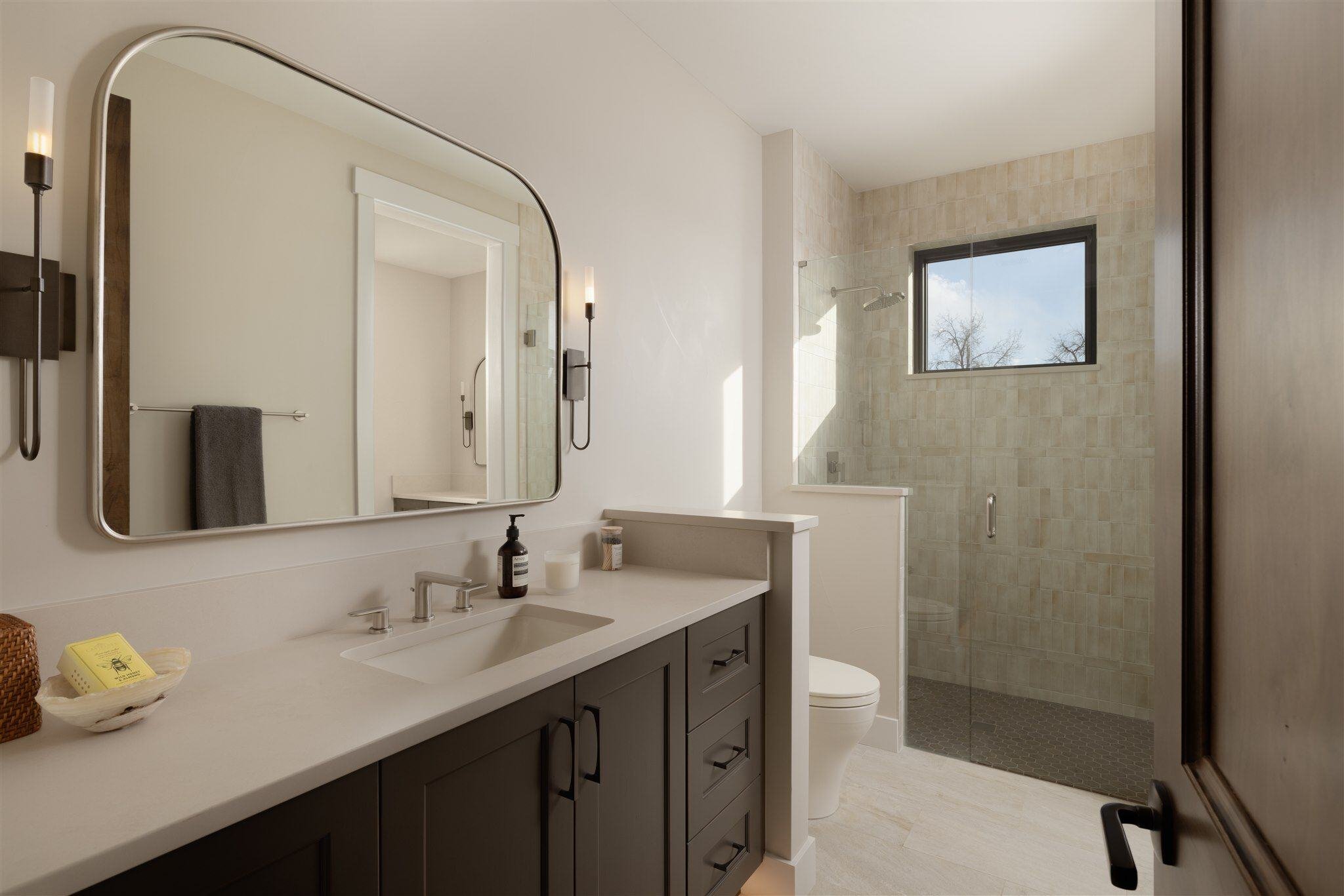 luxury bathroom remodel with brown cabinets, white countertop, and walk in shower in boulder colorado