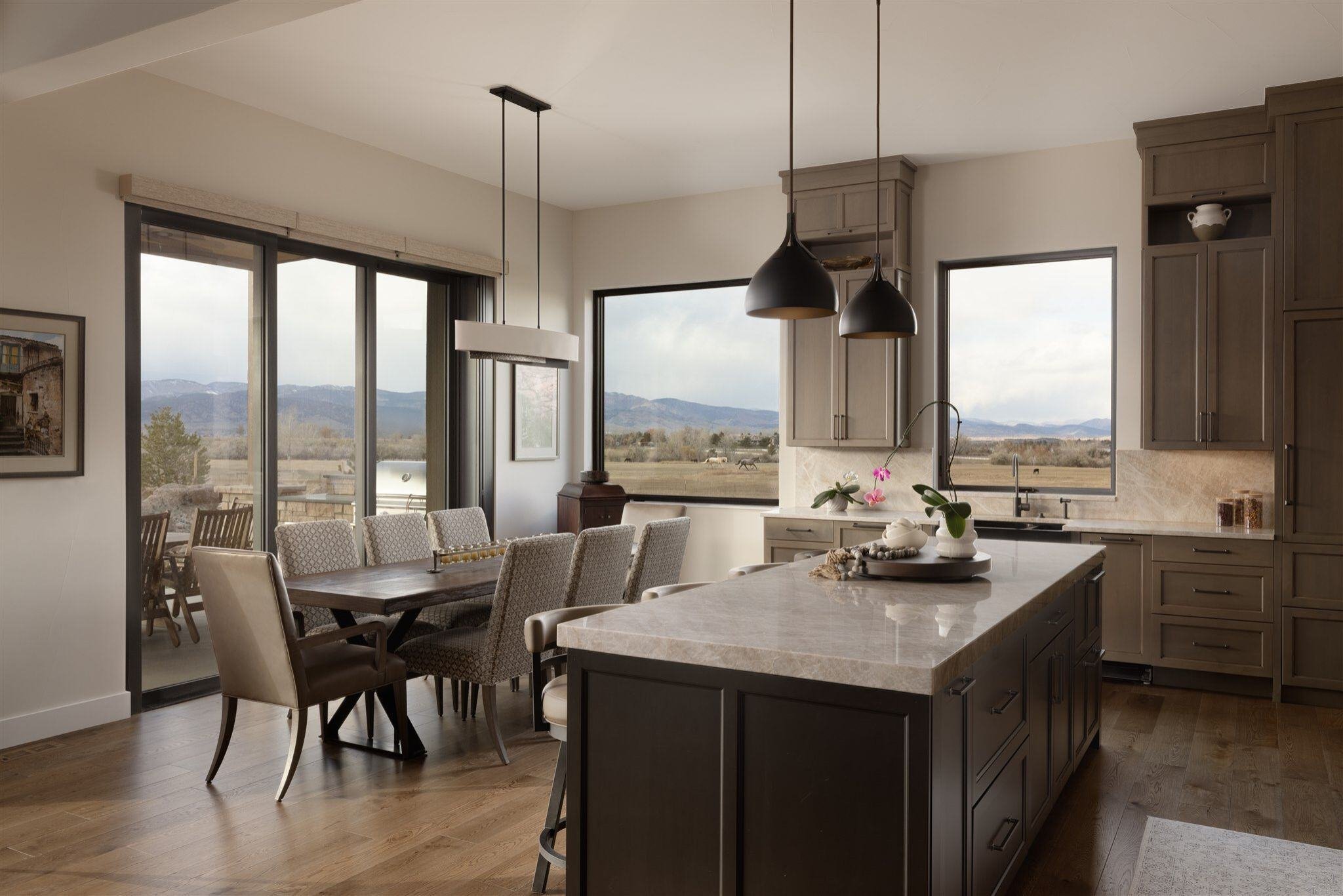 luxury boulder kitchen with dark cabinets, mountain views, and kitchen island with seating