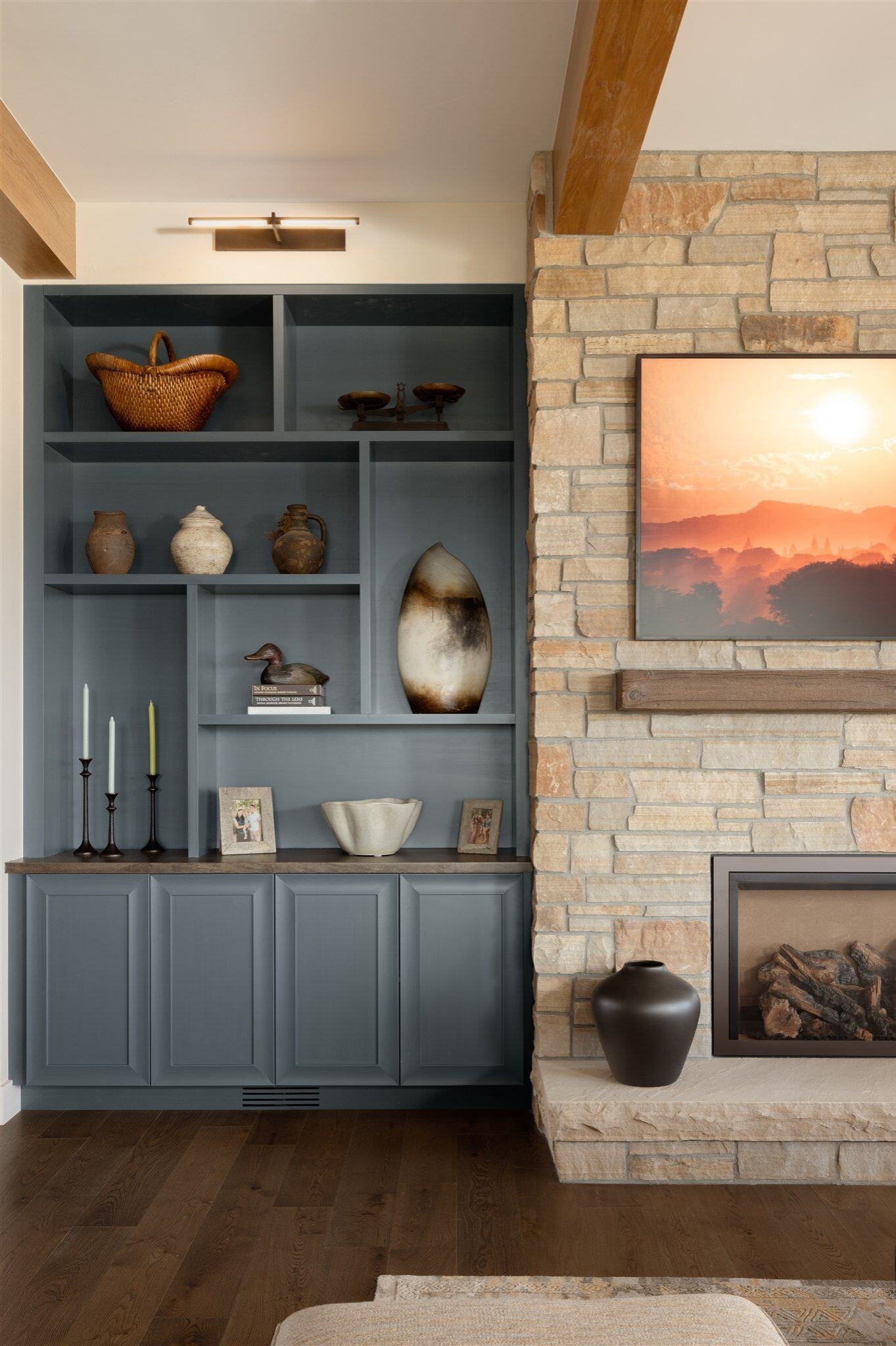 built in shelving next to stone fireplace in a home remodel in boulder colorado