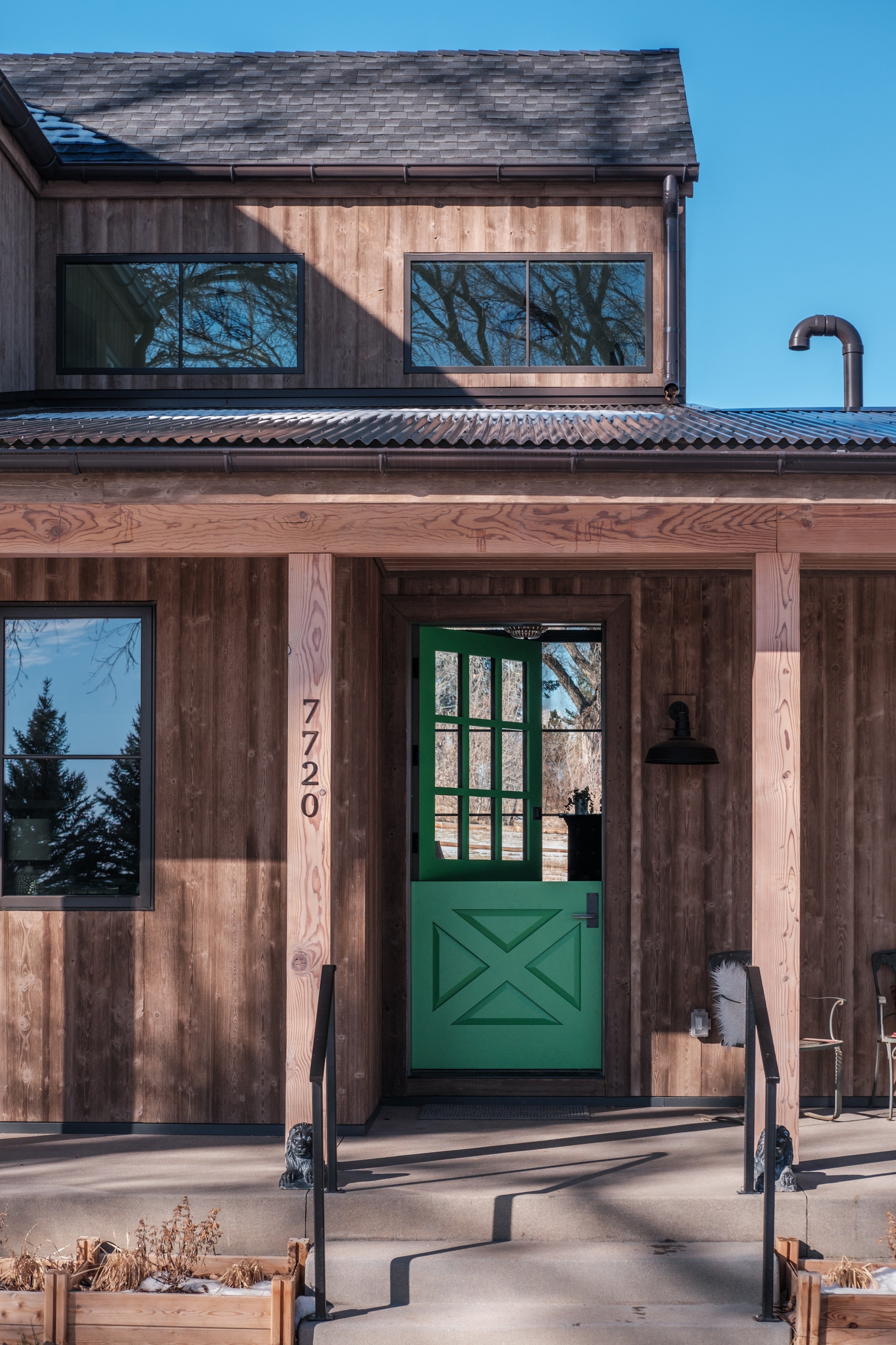 Green front door of a rustic modern home in Boulder Colorado