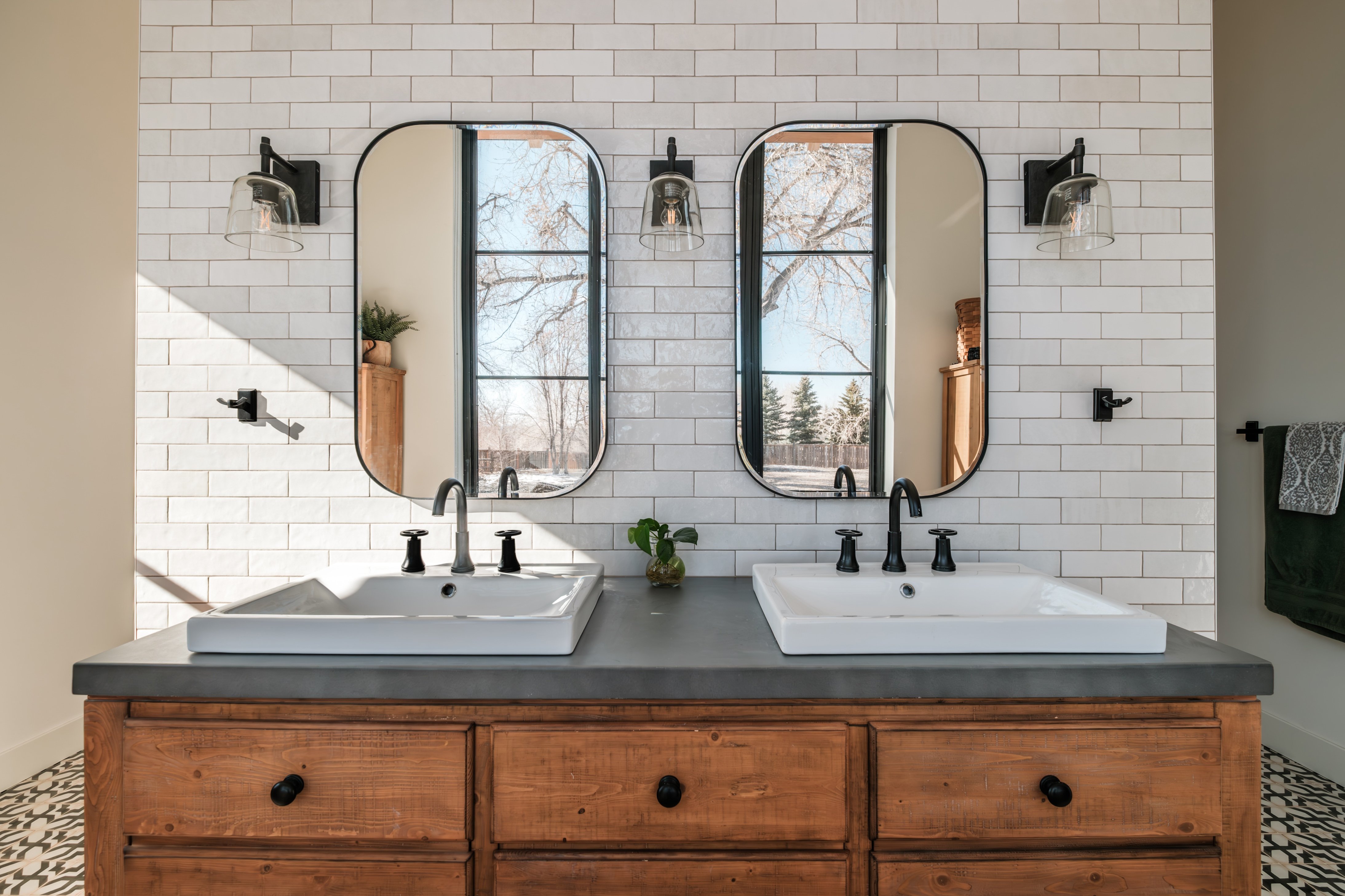 tiled wall with double vanity, wall sconces