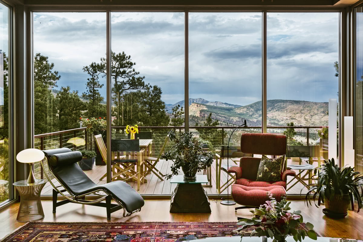 living room with glass windows and mountain view