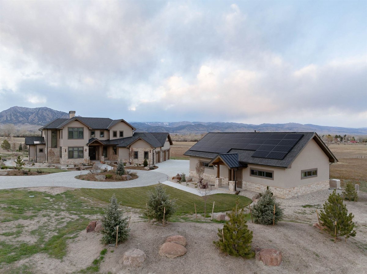 exterior shot of a large custom build home with adu on property with solar panels