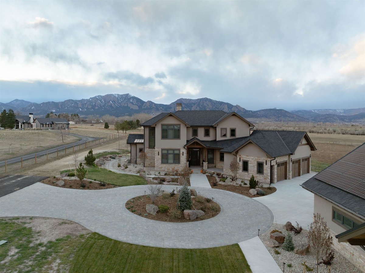 large custom built home in bounder colorado with gray driveway pavers