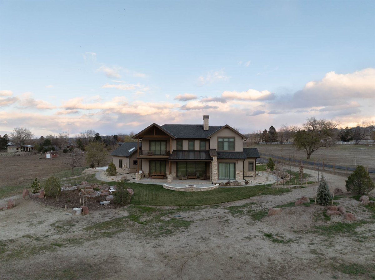 large custom built home backyard in colorado with large patio