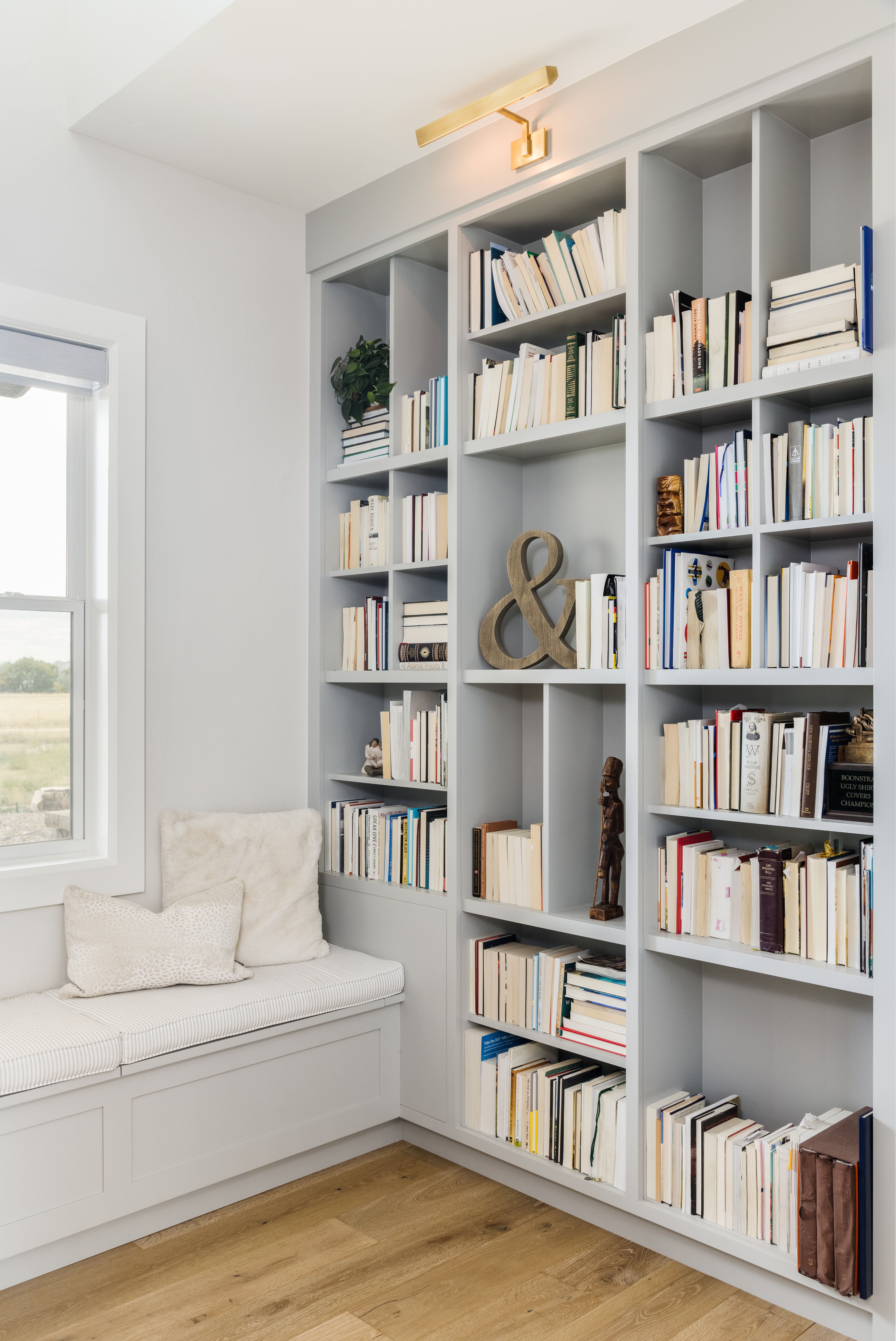 cutom built in bookcase with built in bench under window