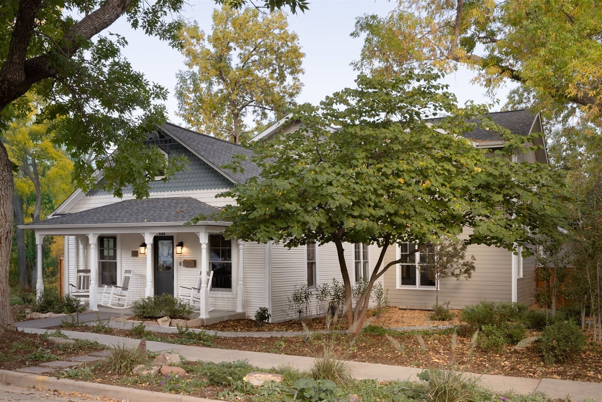 Exterior of Boulder Colorado home with covered front porch with rocking chairs