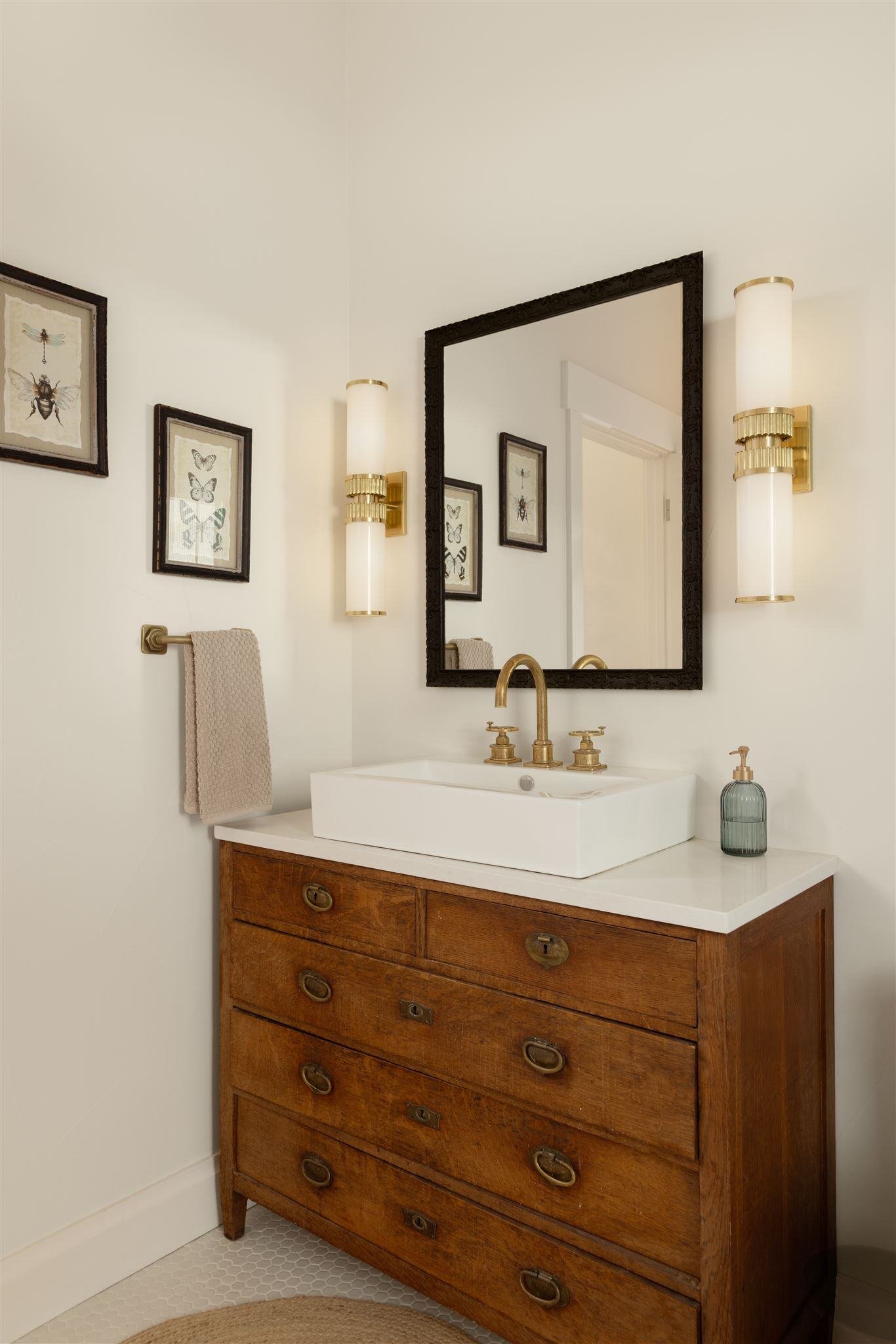 Repurposed wooden bathroom vanity with white countertop