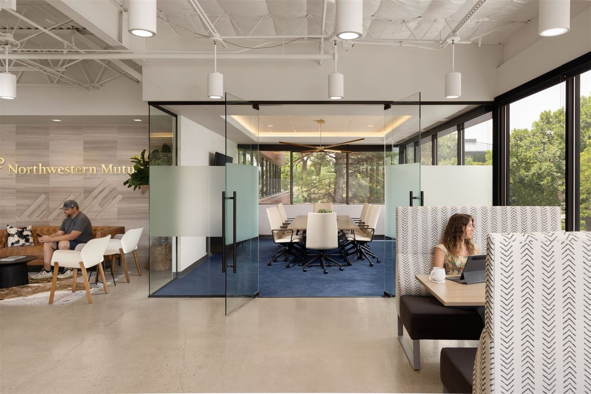 multifunctional. modern office space with glass door meeting room and multiple seating options