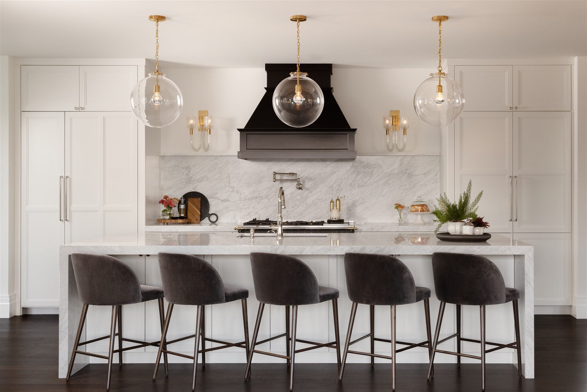 Luxury modern kitchen in boulder colorado with large kitchen island with barstools, and white cabinets