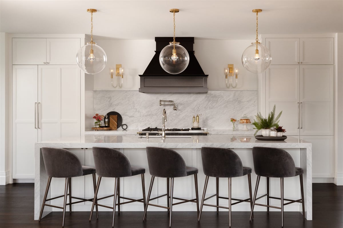 Luxury modern kitchen in boulder colorado with large kitchen island with barstools, and white cabinets