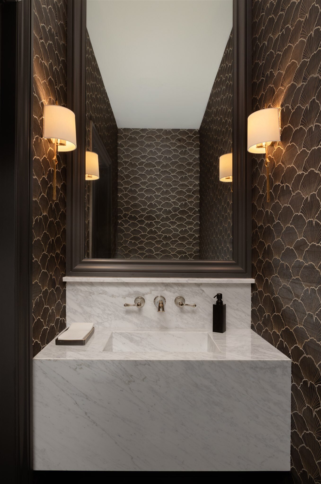 floating marble bathroom vanity in a dark wallpapered bathroom