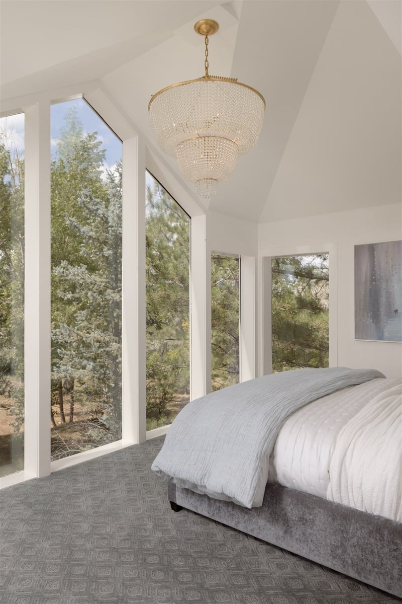 luxury bedroom with floor to ceiling windows and luxury chandelier