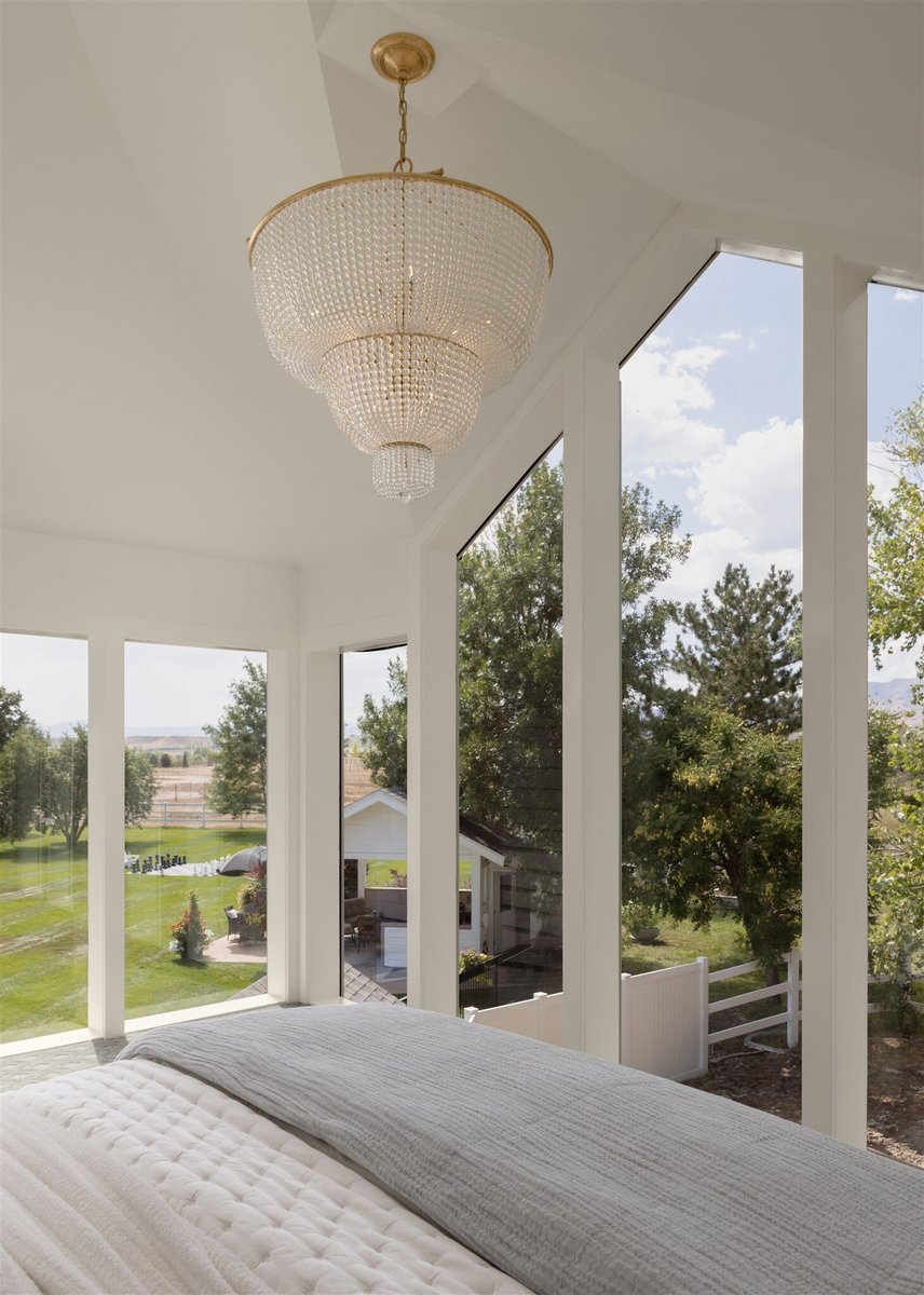 master bathroom with floor to ceiling windows and chandelier