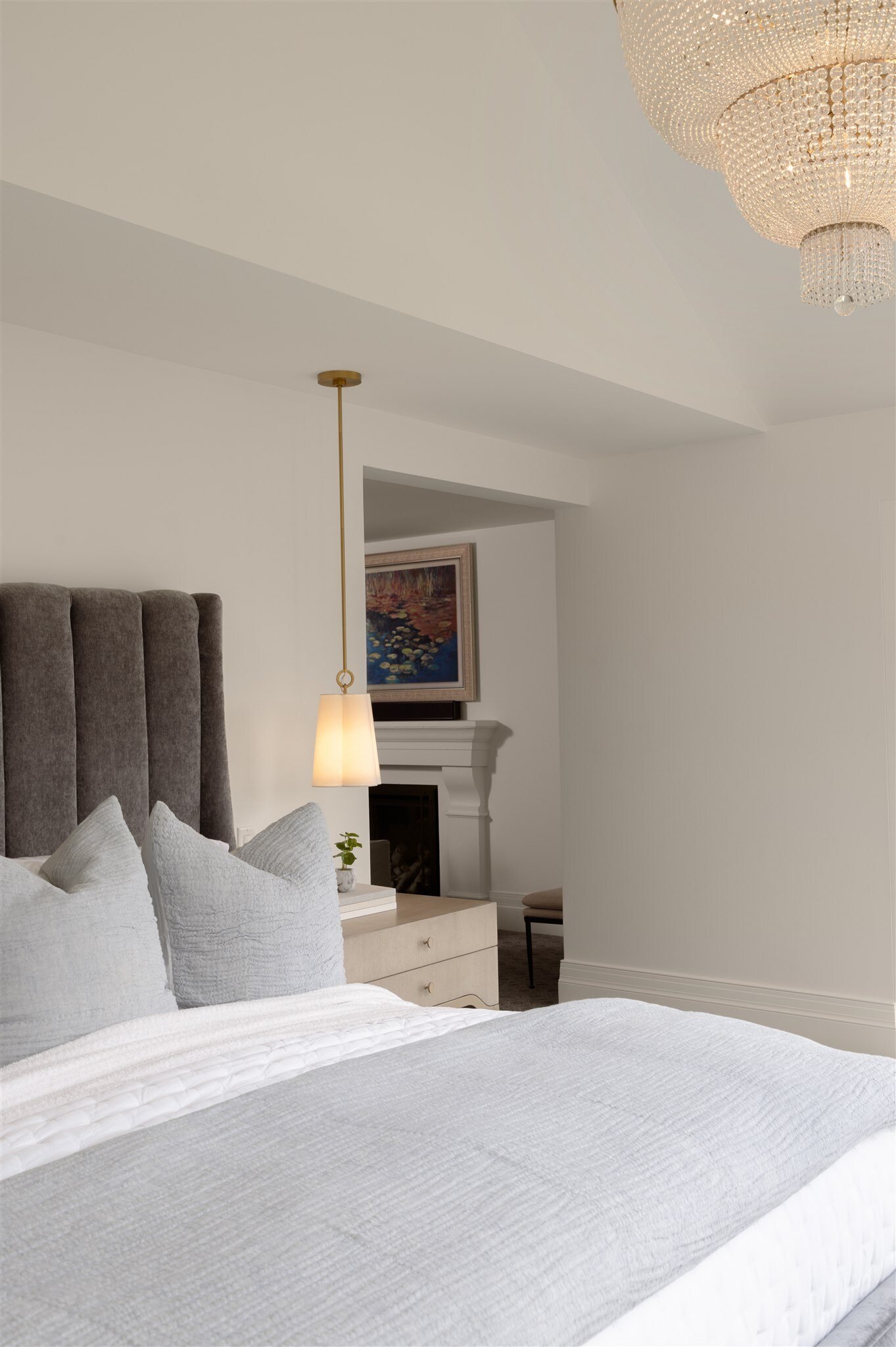 bedroom with custom lighting and a fireplace in a luxury colorado home