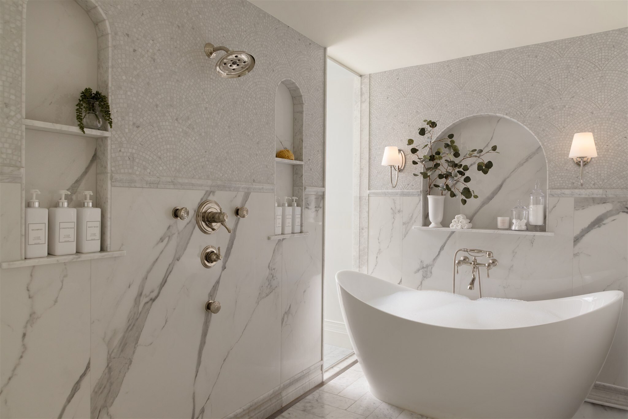 Luxury bathroom remodel with freestanding bath tub and marble tiles