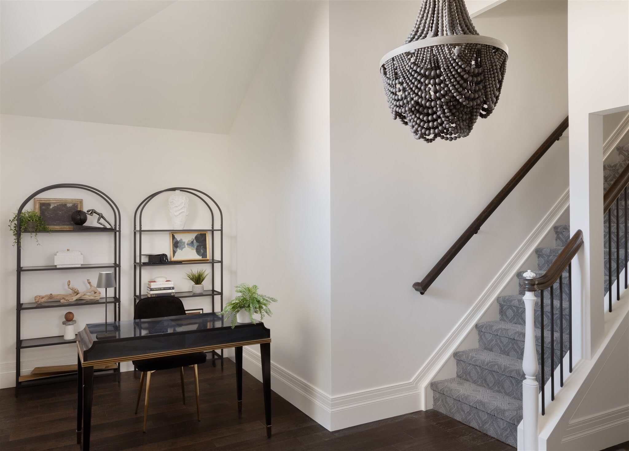 home staircase with a piano and shelves in a luxury home