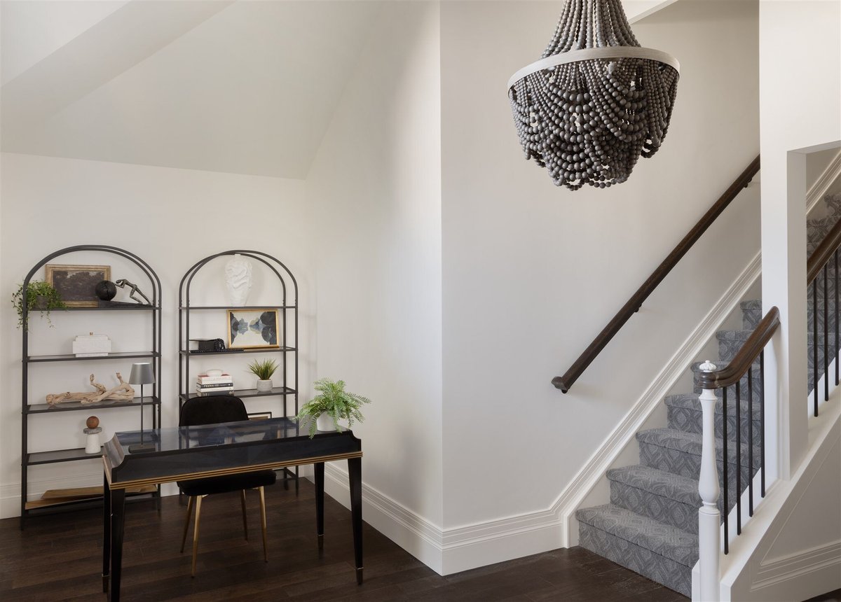 home staircase with a piano and shelves in a luxury home
