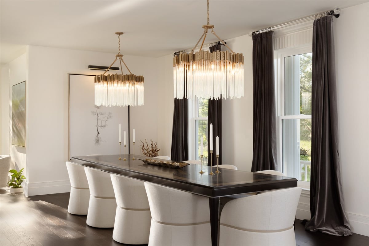 luxury colorado home dining room with large dining table and gold and white chandeliers