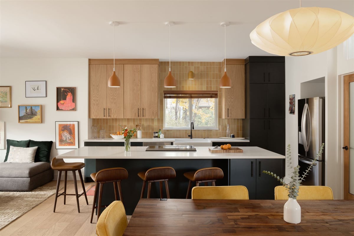 Kitchen remodel with kitchen island seating, two tone cabinets, and white cabinets