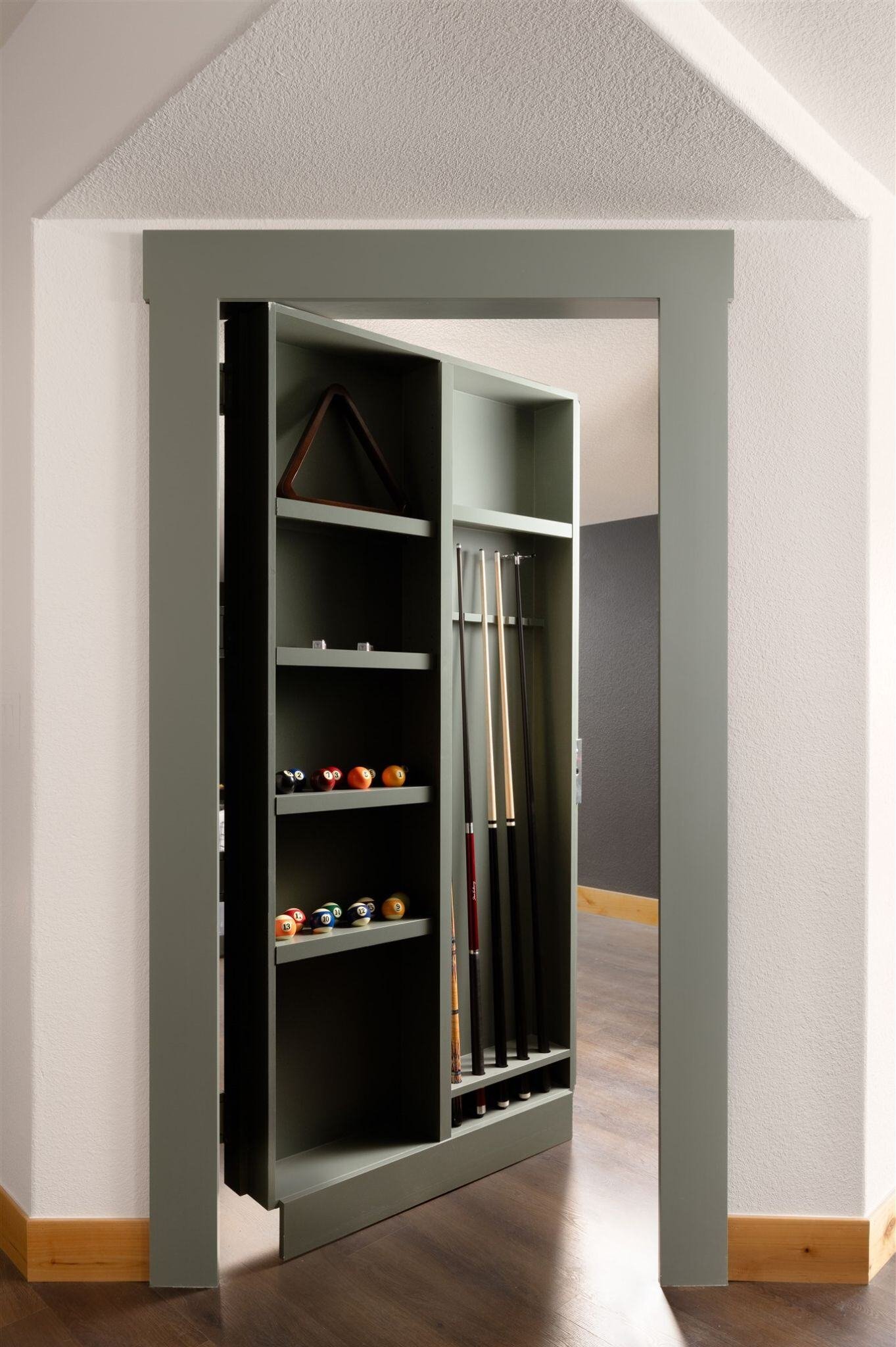 hidden door in basement remodel featuring pool supply storage shelving